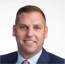 Jeff Seaman, Advisory Board Member at Lukrom, smiling in a professional suit and tie with a white backgroundf