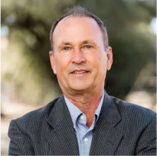 Scott Gould, Advisory Board Member at Lukrom, smiling outdoors with a blurred background