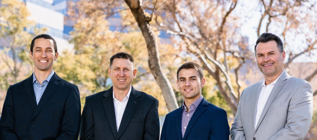 Lukrom management team standing outdoors in business attire